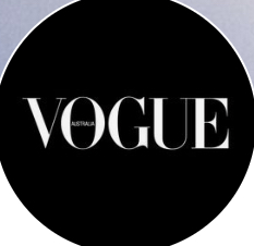 Circular vogue magazine logo with white writing on black background.